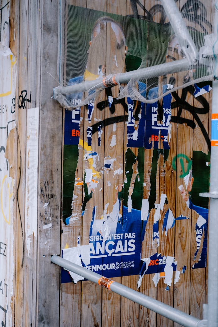 The Art of Drawing Readers In: Your attractive post title goes here Shredded French election posters cover a graffiti-filled city wall.